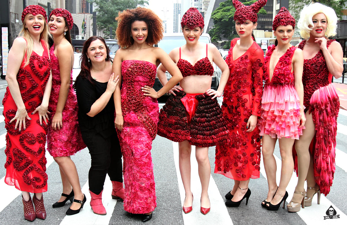Brazilian artist Adriana Bertini posing with models with her condom dresses