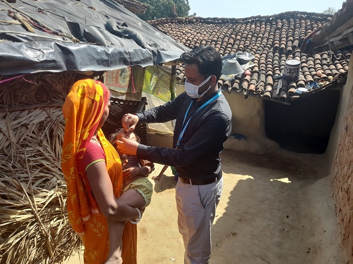healthcare worker administering a vaccine to a child