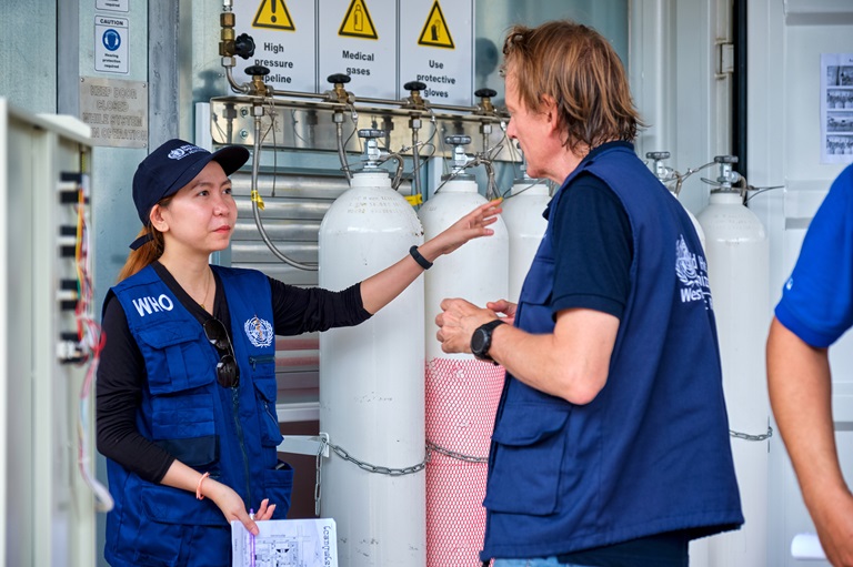man checking the oxygen tanks